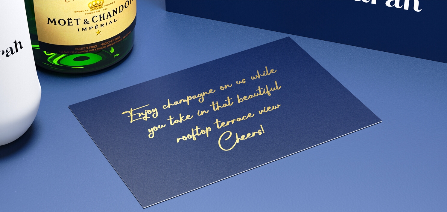 Celebratory champagne flutes and bottle in a personalized gift box.