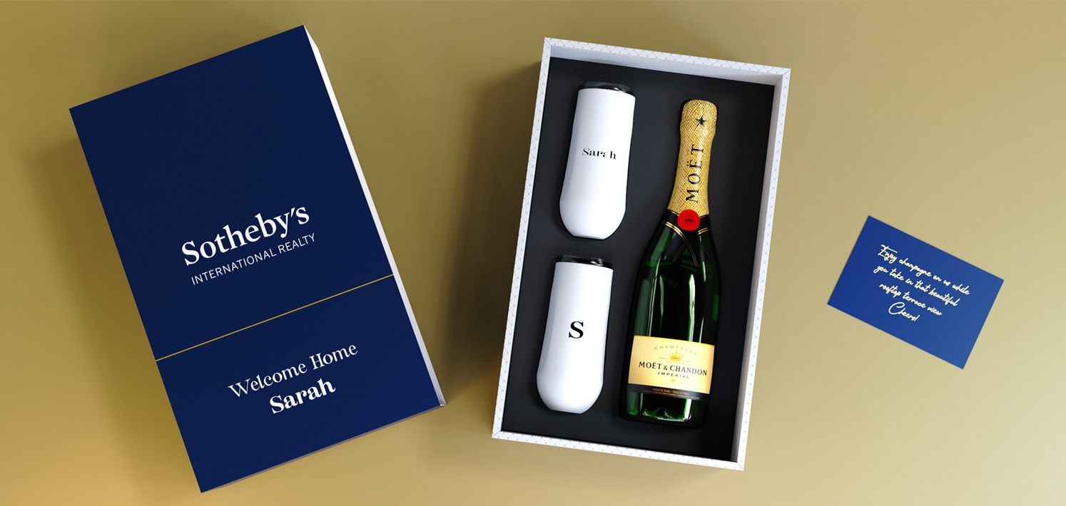 Custom gift box containing champagne and insulated flutes for a memorable gift.